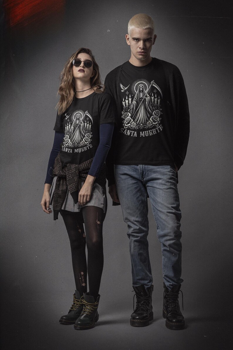 Santa Muerte Gothic Shirt - Holy Death T-Shirt featuring Day of the Dead skull design. Perfect Mexican folk art skeleton top for Dia de los Muertos celebrations or as a unique gift idea. Stylish and symbolic gothic tee for fans of Santa Muerte.