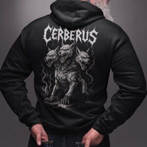 Cerberus Hoodie featuring a three-headed hellhound design inspired by Greek mythology. Gothic sweatshirt perfect for metalheads. Hades guardian graphic, ideal heavy metal gift for fans of dark fantasy and mythology