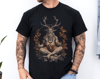 May include: Black t-shirt with a detailed illustration of a seated figure with deer antlers, a long beard, and a necklace. The artwork is surrounded by leaves and a circular design. The shirt is made of a soft material.