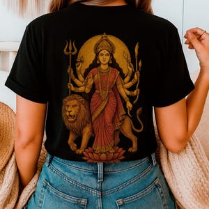 “Maa Durga T-shirt featuring the Hindu goddess of strength and protection, perfect for devotees of the divine feminine and Shakti power. Spiritual yoga clothing with sacred iconography, ideal for those seeking a powerful and meaningful Hindu goddess tee.
