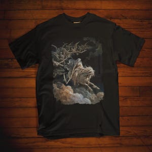 May include: Black t-shirt featuring a graphic print of a skeletal figure riding a horse with bats flying around it.