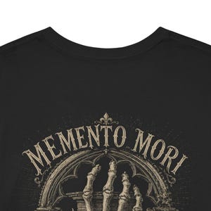 Memento Mori shirt featuring a vintage skeleton hand holding an hourglass, inspired by Stoic philosophy and mortality symbolism. Gothic t-shirt design with dark academia aesthetic, antique engraving style artwork, and memento mori theme. Perfect for lovers of stoicism, philosophy, gothic fashion, medieval art, existential symbolism, and alternative clothing.
