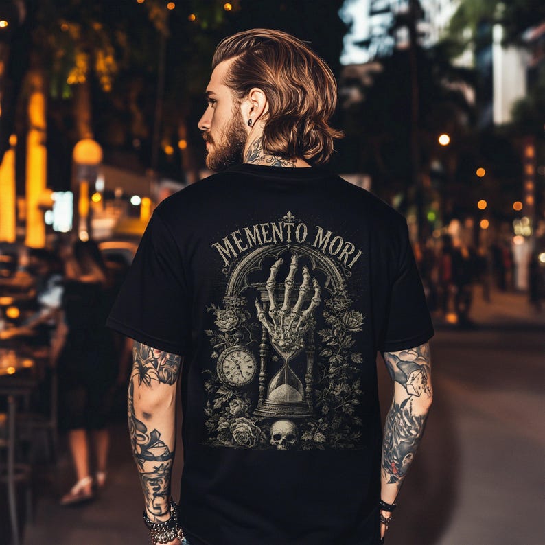 Memento Mori shirt featuring a vintage skeleton hand holding an hourglass, inspired by Stoic philosophy and mortality symbolism. Gothic t-shirt design with dark academia aesthetic, antique engraving style artwork, and memento mori theme. Perfect for lovers of stoicism, philosophy, gothic fashion, medieval art, existential symbolism, and alternative clothing.