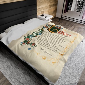 May include: A cream-colored throw blanket with a floral design and a quote from Shakespeare about love. The quote reads: "Rough winds do shake the darling buds of May, And summer's lease hath all too short a date: Sometime too hot the eye of heaven shines, And often is his gold complexion dimmed; And every fair from fair sometime declines, By chance or nature's changing course untrimmed; But thy eternal summer shall not fade, Nor lose possession of that fair thou ow'st; Nor shall death brag thou wander'st in his shade, When in eternal lines to time thou grow'st: So long as men can breathe, or eyes can see, So long lives this, and this gives life to thee."  W. Shakespeare