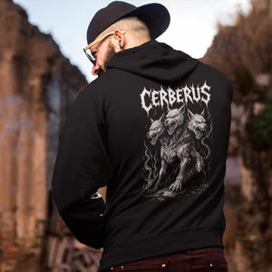 Cerberus Hoodie featuring a three-headed hellhound design inspired by Greek mythology. Gothic sweatshirt perfect for metalheads. Hades guardian graphic, ideal heavy metal gift for fans of dark fantasy and mythology