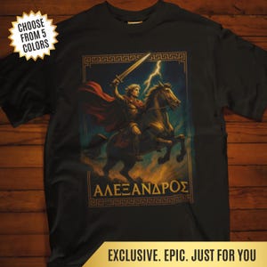 May include: Black t-shirt featuring a warrior on horseback with a sword, a red cape, and a lightning bolt. The image includes the Greek text "ΑΛΕΞΑΝΔΡΟΣ" and a gold border. The shirt also has text that says "CHOOSE FROM 5 COLORS" and "EXCLUSIVE. EPIC. JUST FOR YOU."