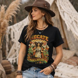 Vintage 70s Hecate retro shirt featuring the Triple Goddess in a mystical boho design, inspired by witchcraft, Wiccan and pagan spirituality. This witchy graphic tee shows Hekate with moon phases and occult symbols, perfect for spiritual women, witches, and lovers of magic. Ideal witchy gift for Wiccan, pagan and boho aesthetic fans.