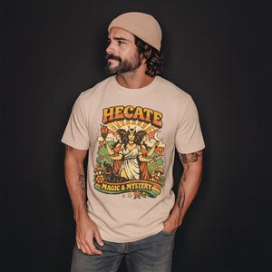 Vintage 70s Hecate retro shirt featuring the Triple Goddess in a mystical boho design, inspired by witchcraft, Wiccan and pagan spirituality. This witchy graphic tee shows Hekate with moon phases and occult symbols, perfect for spiritual women, witches, and lovers of magic. Ideal witchy gift for Wiccan, pagan and boho aesthetic fans.
