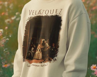 May include: A beige sweatshirt with a graphic print of a painting by Velazquez, "Las Meninas (1656)".