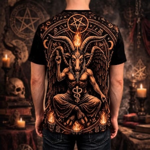 Puede incluir: Camiseta negra con una ilustración detallada en naranja y negro de Baphomet, una deidad con cabeza de cabra, rodeada de símbolos ocultos y llamas. El diseño presenta detalles intrincados y una estética gótica.