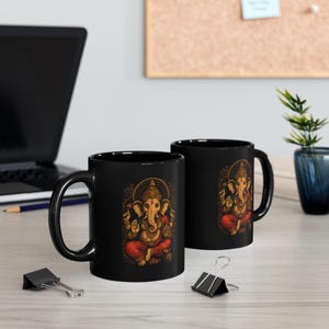 Black Ganesha Mug featuring Hindu Elephant God design, perfect for yoga lovers and spiritual gifts. Boho Indian graphic print. Available in 11oz and 15oz sizes. Ideal for tea or coffee, a unique addition to your collection