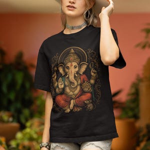 Spiritual Ganesha T-shirt featuring Hindu Elephant God design. Perfect for yoga, meditation, and spiritual gifts. Boho Indian graphic tee celebrating divine feminine energy and peaceful vibes.