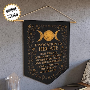 May include: Black banner with gold text and design, featuring the words "INVOCATION TO HECATE" and "HAIL HECATE, QUEEN OF THE NIGHT." The banner has a crescent moon design and floral accents. It is hung from a wooden rod. The banner is labeled "UNIQUE DESIGN."