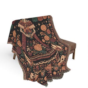 La Catrina woven blanket featuring colorful Dia de los Muertos folk art and an elegant calavera woman design. A striking Day of the Dead wall hanging, Mexican folk art tapestry, or decorative throw for gothic and sugar skull decor lovers, and a unique calavera gift inspired by traditional Mexican imagery.