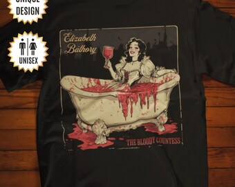 May include: Black t-shirt featuring a graphic of Elizabeth Báthory, the Bloody Countess, in a bathtub filled with blood. The graphic is in a vintage style with a red and white colour scheme. The text "Elizabeth Báthory" and "The Bloody Countess" are included in the graphic.