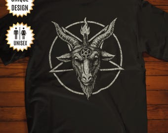 May include: A black short-sleeved t-shirt featuring a white graphic of a goat head with horns and a flame between them, centered within a pentagram. The shirt includes two star-shaped badges with the text UNIQUE DESIGN and UNISEX.