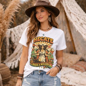 Vintage 70s Hecate retro shirt featuring the Triple Goddess in a mystical boho design, inspired by witchcraft, Wiccan and pagan spirituality. This witchy graphic tee shows Hekate with moon phases and occult symbols, perfect for spiritual women, witches, and lovers of magic. Ideal witchy gift for Wiccan, pagan and boho aesthetic fans.