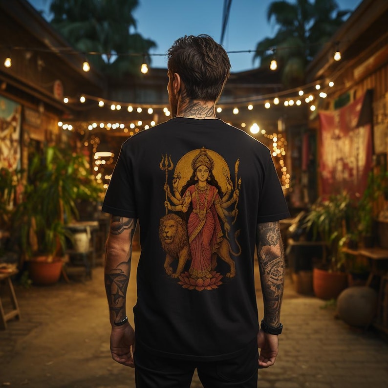 “Maa Durga T-shirt featuring the Hindu goddess of strength and protection, perfect for devotees of the divine feminine and Shakti power. Spiritual yoga clothing with sacred iconography, ideal for those seeking a powerful and meaningful Hindu goddess tee.