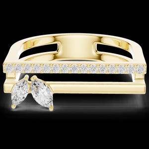 May include: A gold-colored ring with a rectangular design. The top section is adorned with a row of small, clear gemstones. Two marquise-cut gemstones are positioned on the lower section of the ring, adding a unique touch to the jewelry.