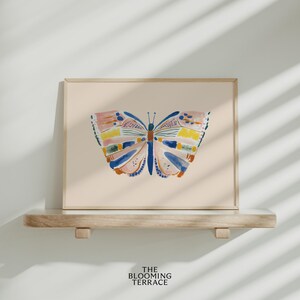 Hand-painted butterfly with bold brushstrokes in orange, pink, blue, and yellow on a soft peach background. Colorful whimsical digital wall art, perfect for nursery, kids’ bedroom, or playful spring decor.