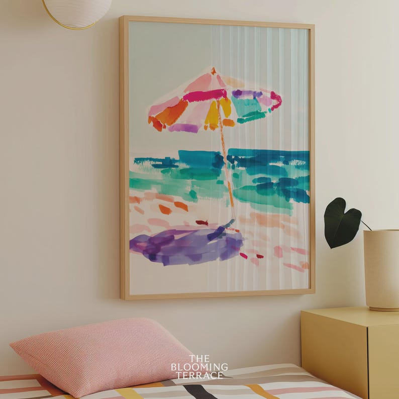 Bright watercolor-style painting of a colorful beach umbrella by the ocean — vibrant coastal wall art printable for summer home decor.