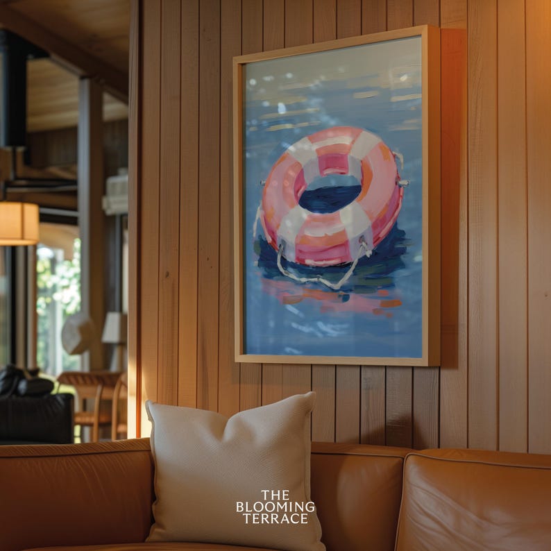 Digital painting of a pink and white lifebuoy floating on calm blue water. Bright and playful coastal art with summery, nautical vibes.