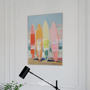 Digital wall art of four colorful surfboards in shades of coral, orange, yellow, and pink standing on a beach — perfect printable art for coastal or summer home decor.