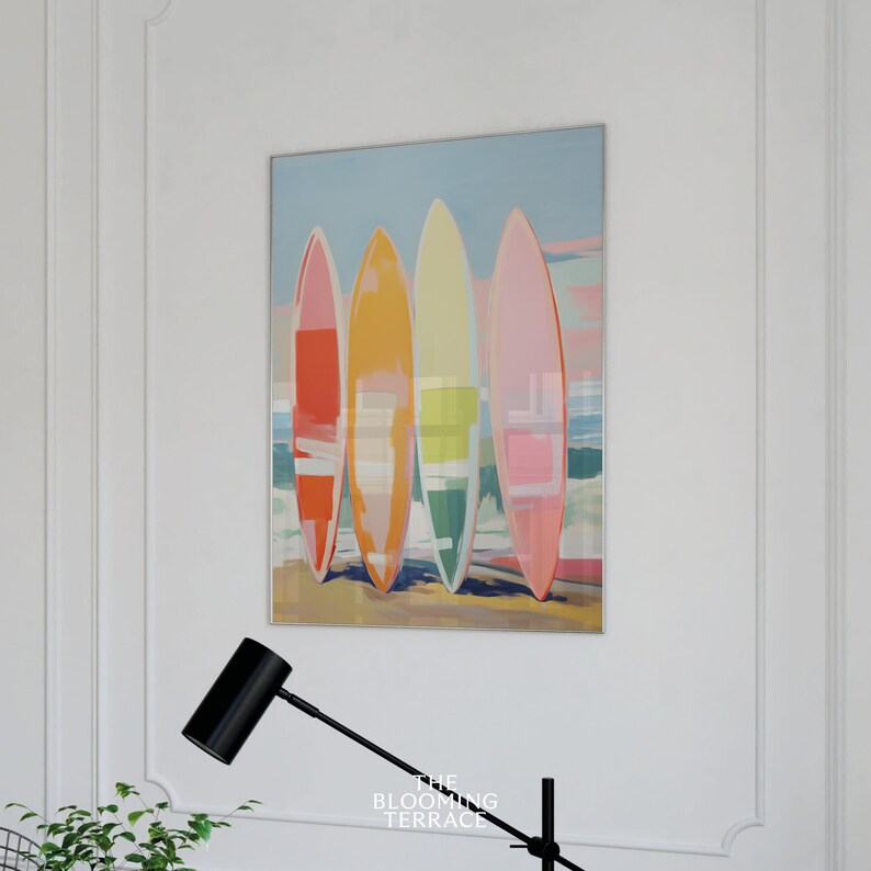 Digital wall art of four colorful surfboards in shades of coral, orange, yellow, and pink standing on a beach — perfect printable art for coastal or summer home decor.
