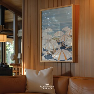 Beach scene featuring striped umbrellas and sunbathers by the calm ocean, painted in soft blue, peach, and cream tones — printable coastal wall art.