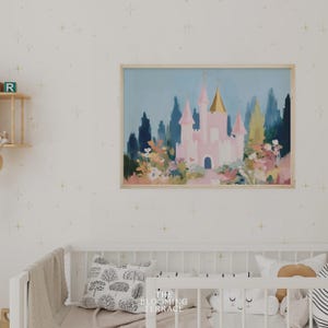 Whimsical pink fairytale castle with golden spires surrounded by colorful flowers and greenery, set against a dreamy blue sky. Digital download wall art perfect for nursery, girls bedroom, or princess-themed decor.