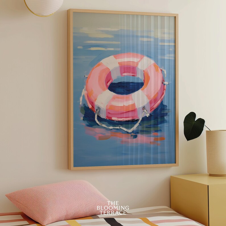 Digital painting of a pink and white lifebuoy floating on calm blue water. Bright and playful coastal art with summery, nautical vibes.