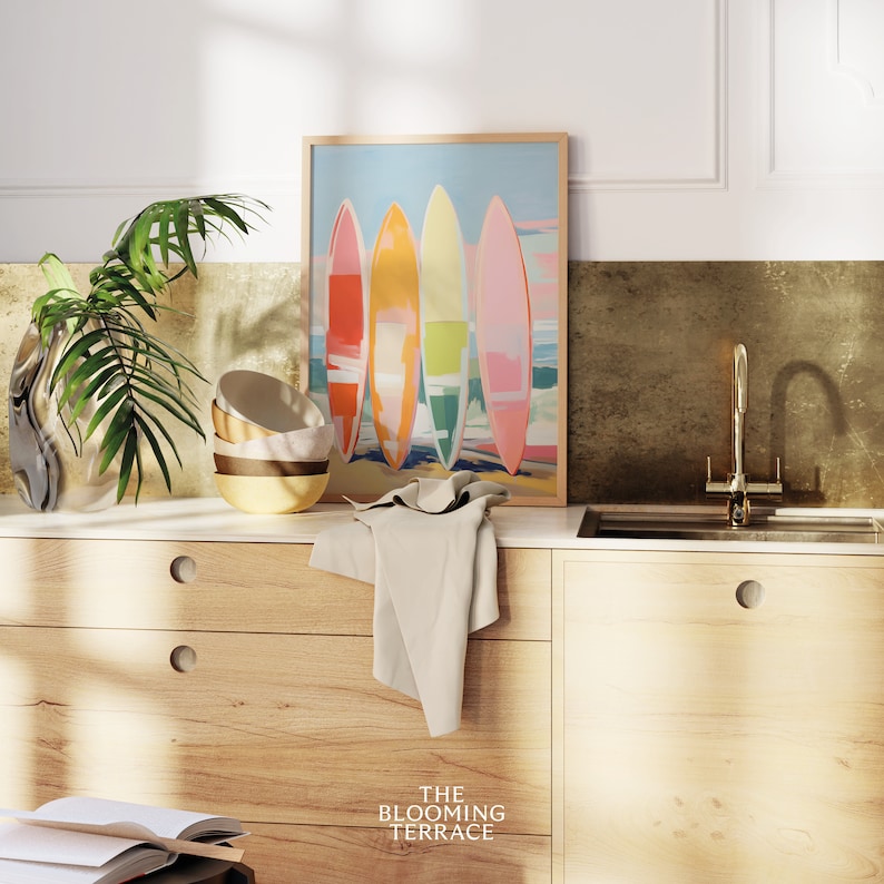Digital wall art of four colorful surfboards in shades of coral, orange, yellow, and pink standing on a beach — perfect printable art for coastal or summer home decor.