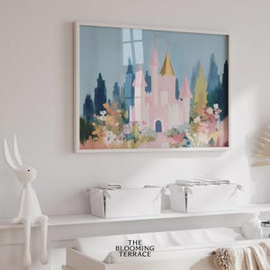 Whimsical pink fairytale castle with golden spires surrounded by colorful flowers and greenery, set against a dreamy blue sky. Digital download wall art perfect for nursery, girls bedroom, or princess-themed decor.