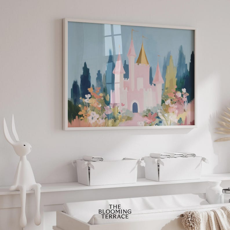 Whimsical pink fairytale castle with golden spires surrounded by colorful flowers and greenery, set against a dreamy blue sky. Digital download wall art perfect for nursery, girls bedroom, or princess-themed decor.