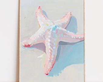 May include: A framed painting of a starfish. The starfish is painted in shades of pink, with white and blue accents. The painting has a light blue and gray background, and the frame is a light wood color.
