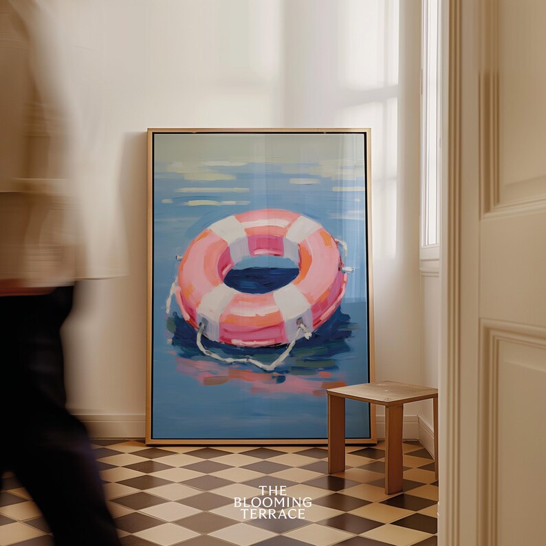 Digital painting of a pink and white lifebuoy floating on calm blue water. Bright and playful coastal art with summery, nautical vibes.