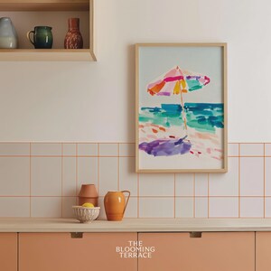 Bright watercolor-style painting of a colorful beach umbrella by the ocean — vibrant coastal wall art printable for summer home decor.