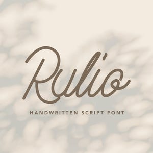 May include: A digital graphic featuring the word "Rulio" in a flowing, handwritten script font. Below the word, the text reads "HANDWRITTEN SCRIPT FONT" in a smaller font. The background has a soft, blurred effect with light and dark areas.