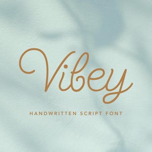 May include: The word "Vibey" in a handwritten script font, in a warm brown color, is centered on a light blue background. Below the word "Vibey" is the text "Handwritten Script Font" in a similar brown color.