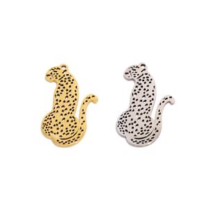 May include: Two metal leopard charms, one gold and one silver, with a detailed spotted design.