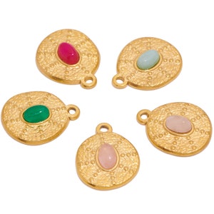 May include: Five gold-toned pendants with different colored gemstones. Each pendant features a textured circular design with a small loop for attaching to a chain.