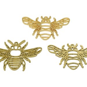 May include: Three gold metal bee charms with intricate cutout designs. The bees have wings, bodies, and legs.