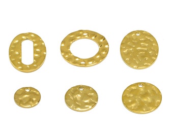May include: Six gold-toned metal charms with hammered textures.  Two charms are round with a hole in the center, two are round with a hole at the top, and two are oval with a hole in the center.