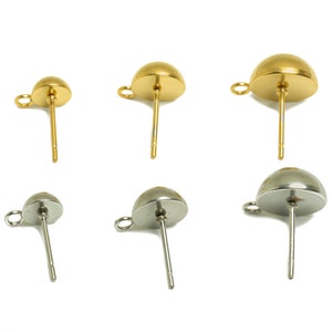 May include: Six earring backs, three gold and three silver, with a rounded top and a post for attaching to earrings.