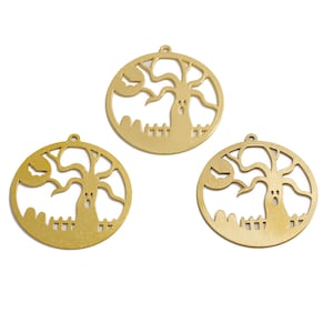 May include: Three gold-colored metal Halloween ornaments shaped like a circle with a cutout design of a spooky tree with a ghost inside.