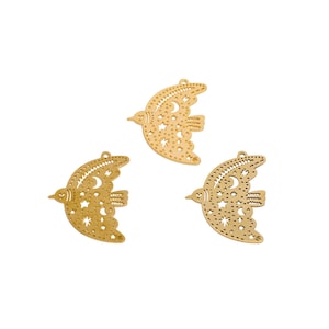 May include: Three gold-colored bird-shaped charms with intricate cut-out designs. Each charm features a crescent moon and star pattern within the wings and body, with a small hole at the top for hanging. The charms are on a white background.