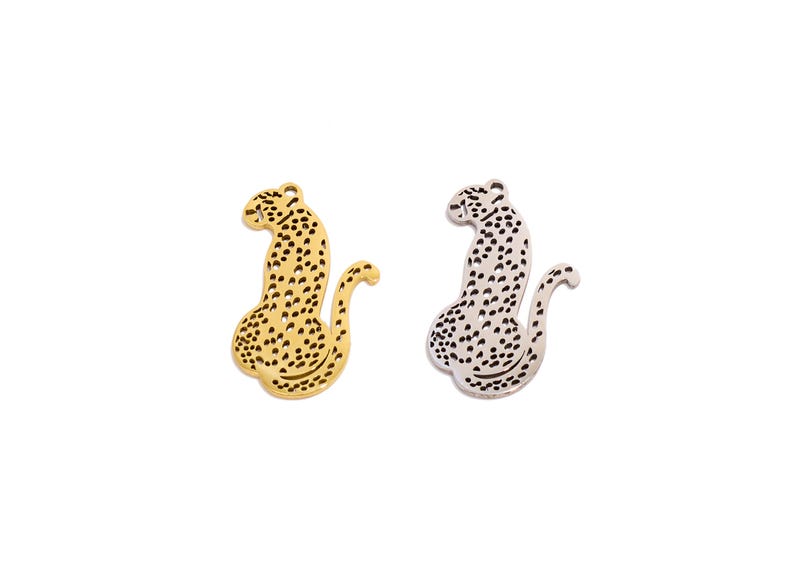 May include: Two metal leopard charms, one gold and one silver, with a detailed spotted design.