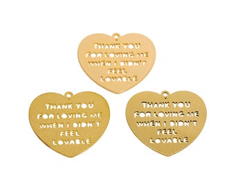 May include: Three gold heart-shaped charms with the text "Thank you for loving me when I didn't feel lovable" on each charm.