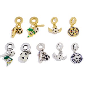 May include: A selection of soccer-themed charms. Gold-toned charms include soccer balls, football boots, and winged footballs. Silver-toned charms feature football designs and the word "love".