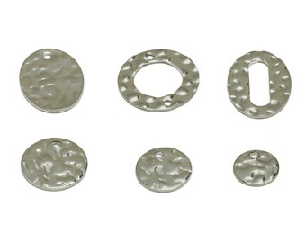 May include: Six silver metal charms with a hammered texture. The charms are in various shapes, including circles, ovals, and a ring.
